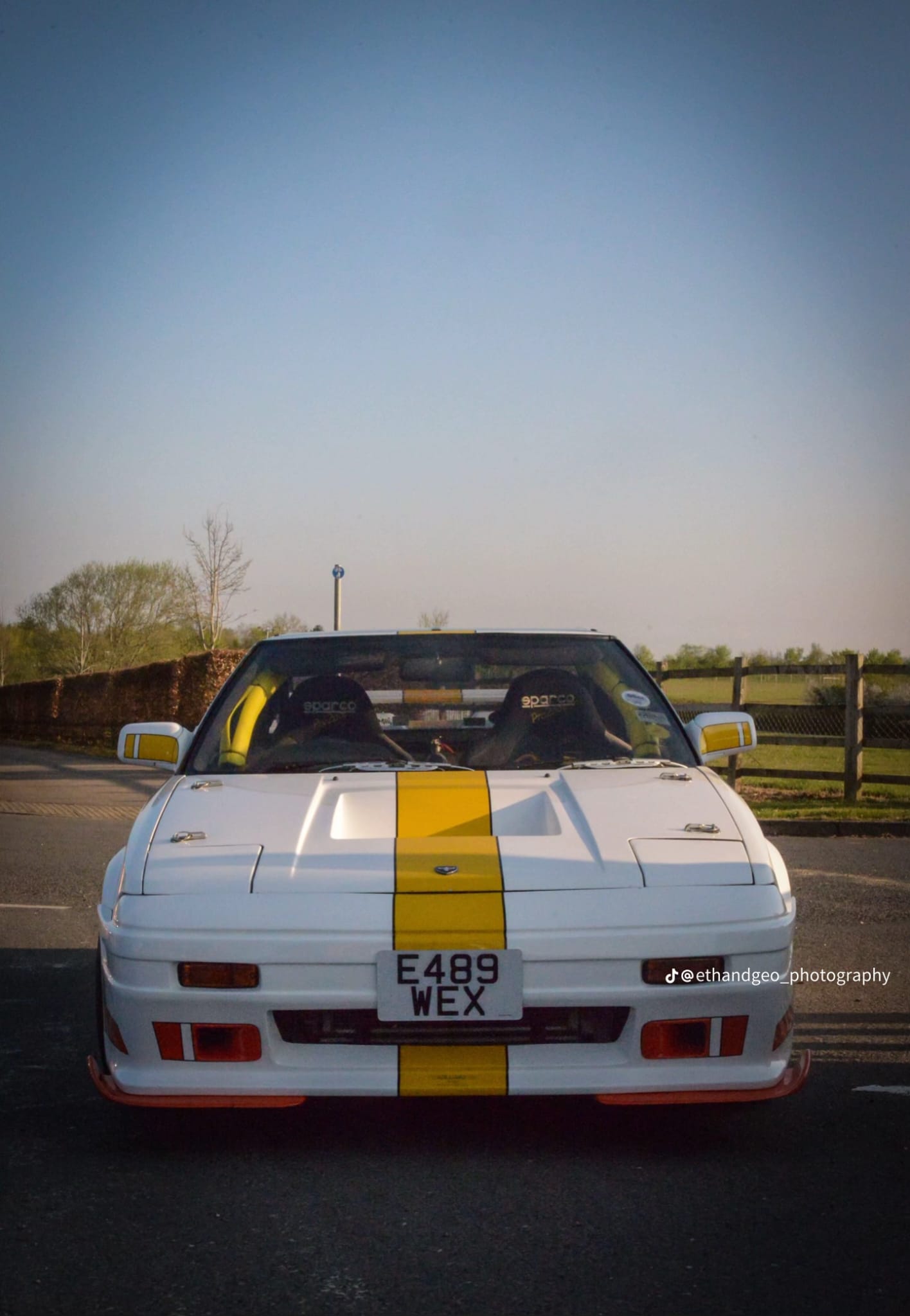 White MR2 MK1 with yellow racing stripe